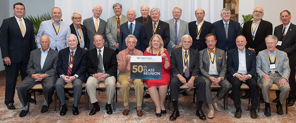 Members of the MD Class of 1969 sit and pose for a photo at their 50th reunion