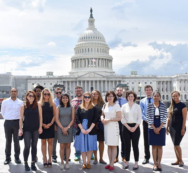 Graduate students stand in front of the US Capitol Building in Washington DC