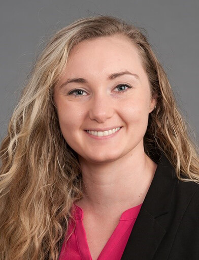 A woman with long hair smiling at the camera.