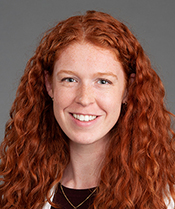A woman with long hair smiling at the camera.