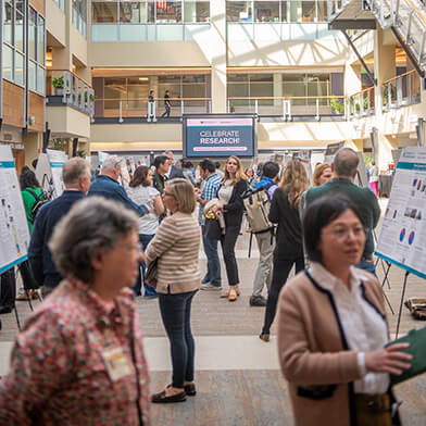  A large group of onlookers view poster presentations.
